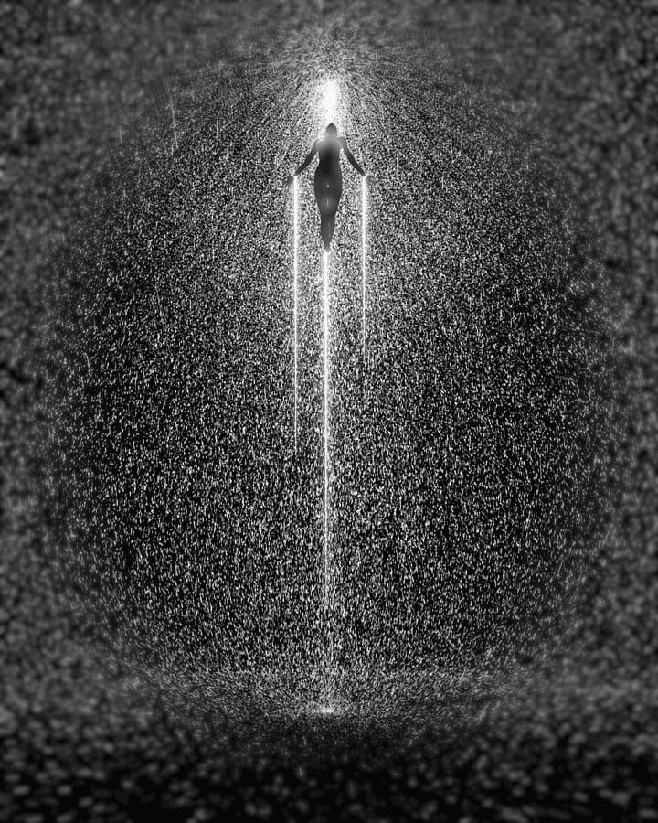Figure in Vertical Light Rain