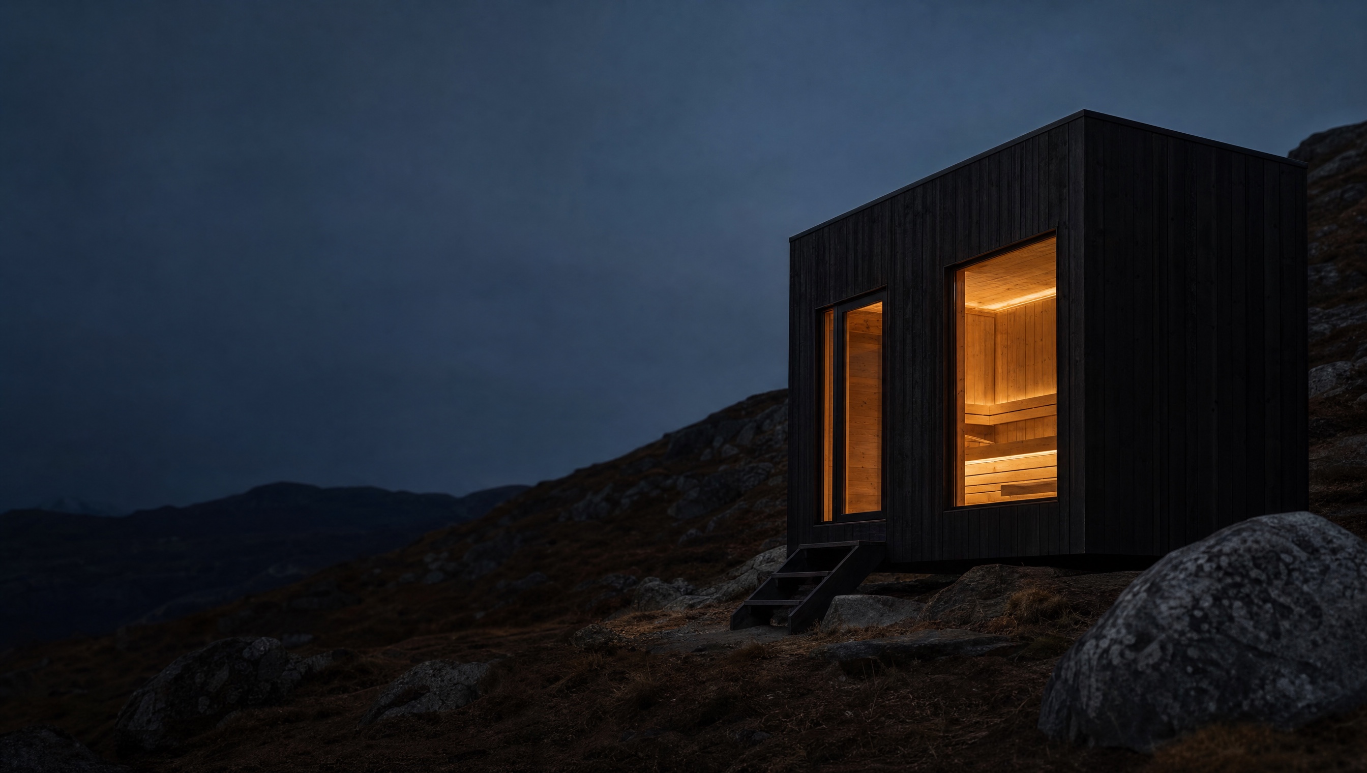 A GLØD sauna glowing warm at dusk on a raw Nordic hillside